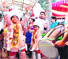 Children dressed as langoors dance on the beats of dhol during the mela.