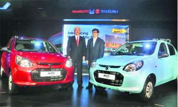 Maruti Suzuki managing director and CEO poses with the new Alto 800 during its launch in New Delhi on Tuesday. The new Alto is introduced in both petrol and CNG options, offered at introductory prices ranging between Rs 2.44 lakh and Rs 3.56 lakh.