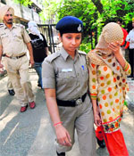 The accused, constable Rajesh Kumar and constable Niharika, being taken to a court in Chandigarh on Tuesday.