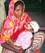 Mauled by stray dogs, three-year-old Harmanpreet in her mothers lap at the government hospital in Odhan in Sirsa on Tuesday