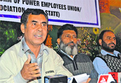 Jammu and Kashmir Power Employees and Workers United Front president Rafiq Ahmad Khanyari addresses a press conference in Srinagar on Tuesday