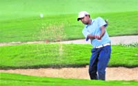 Indias Anirban Lahiri hits out of a bunker during a skill game between India and Rest of World in Bangalore on Tuesday