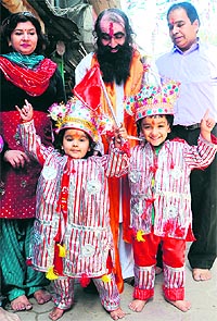 Devotees with their children dressed as langoors at the Langoor Mela at Bada Hanuman Mandir in the Durgiana Temple complex, Amritsar