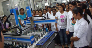 Students of Vivekananda Institute of Management and Technology look at an automatic colour dispenser during an educational trip to textiles unit in Ludhiana