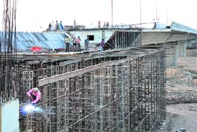 Workers at the 500-metre long bridge on the Tawi in Jammu