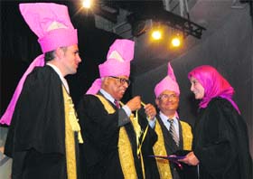 Governor NN Vohra along with Chief Minister Omar Abdullah awards a degree and a medal to a student during the special convocation ceremony at University of Kashmir on Wednesday