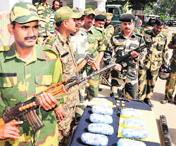 BSF officials show the seized contraband in Amristar. 