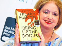 Author Hilary Mantel poses with her book Bring up the Bodies in London