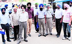 The teachers, who were summoned to appear in the court following the FIR lodged by the Khalsa College Management in March 2011, enter the court complex in Amritsar on Thursday