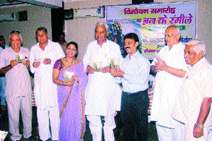 Chief Parliamentary Secretary Prahlad Singh Gillankhera, flanked by Rajnish Kaur and Anil Sharma, releases Brij Ke Rangeele, a CD of devotional songs at Fatehabad. 