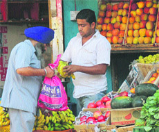 A customer uses a polythene bag in Jammu on Thursday.  