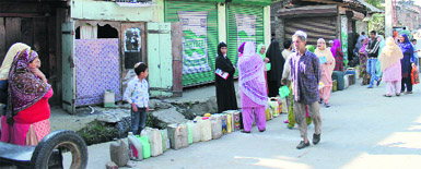 With the recent cap on LPG cylinders, people line up to get kerosene in Srinagar on Thursday. 