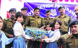 CRPF officials distribute computers to schoolchildren in Sumbal on Thursday.