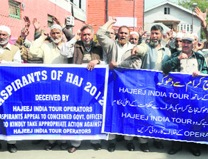 Haj pilgrims hold a protest against Hajeej Hospitality in Srinagar on Thursday.