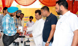 Visitors to the PEDA exhibition try to comprehend the functioning of the solar devices on display