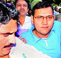 Officials of the CBI take SP Deshraj Singh (blue T-shirt) to the district courts in Chandigarh on Friday