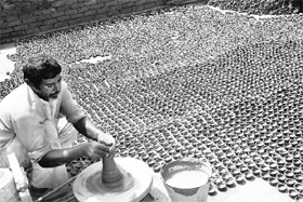 As the festival of lights draws nearer, this man is busy preparing earthen lamps in Rohtak on Friday.