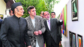 Chief Minister Omar Abdullah along with ICCR president Karan Singh looks at paintings and photographs at the Kashmir unit of the Indian Council for Cultural Relations on the banks of the Dal Lake in Srinagar.