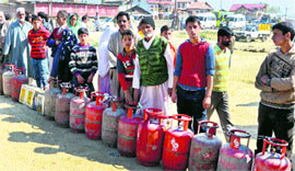 People in a queue with LPG cylinders.