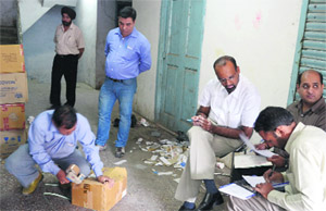 Officials of the health department check drugs in a shop at Pindi Street, Ludhiana, on Friday. 