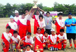 The under-14 team of Strawberry Fields World School celebrate after winning the Chairmans Cup Soccer Tournament at Tau Devi Lal Stadium in Panchkula on Saturday.