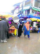 Pedestrians face a tough time as rainwater entered the bus stand in Kupwara.