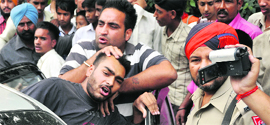 Students clash outside Guru Nanak Stadium in the presence of a policeman in Ludhiana on Saturday. 