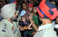 SSP Ravcharan Singh Brar (left) tries to pacify the crowd that gathered in Dhobi Bazaar after two youths were allegedly slapped by policemen on duty in Bathinda on Sunday evening