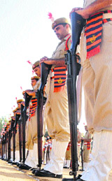 Police personnel reverse their guns as a mark of respect  at Sector 17 in Chandigarh on Sunday. 