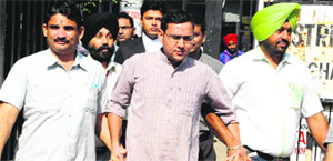 The Accused, Deshraj Singh, SP (City) (centre), at the District Courts in Sector 17, Chandigarh, on Sunday. 