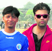 Dehradun footballer Virendra Rawat with film director Karan Johar in the city on Sunday.