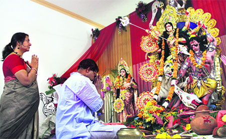 A devotee offers prayers in front of the idol of Goddess Durga in Jalandhar on Sunday