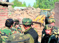 Armymen at a house where two militants of LeT were killed during an encounter at Sopore on Sunday