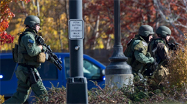 Police and swat team members respond to shooting in Brookfield, Wisconsin, on Sunday.