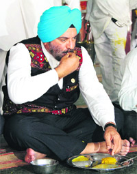 General (retd) J. J. Singh, Governer of Arunachal Pradesh, partake of langer at the Golden Temple in Amritsar on Sunday. 
