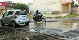 Over flowing sewage poses serious hazard to the commuters on a road in Ferozepur.