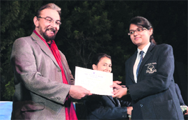Film actor Kabir Bedi gives away a prize to a student during the founder's day celebrations of Asian School 