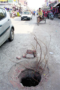 Such open manholes on a road at Kharkhoda (Sonepat) connecting Bahadurgarh (Jhajjar) and Sampla (Rohtak) are virtual death-traps for commuters. This 25-foot-deep manhole at Kharkhoda has been lying uncovered for the past over two months.