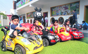 Children enjoy rides at the opening of a new school at Model Town in Jalandhar on Monday. 