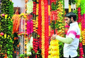 A shopkeeper displays decorations in the run up to the festival of Diwali at Pakka Danga market in Jammu.