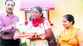 Secretary of the Red Cross Society, Amritsar, Thakur Randhir Singh hands over an abandoned child to the staff at an orphanage at Talwandi Dham near Jagraon.