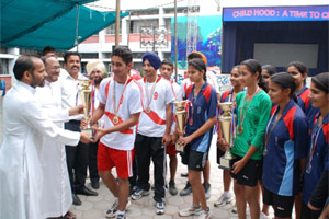 Principal of St. Xaviers School, Bathinda, Father Eulalio Fernandes (left) greets the school team that emerged winners in the CBSE North Zone-II Handball Championship held at Hissar in Haryana.