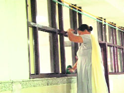 A woman cleans windows at the General Hospital ahead of Chief Parliamentary Secretary Ram Kishan Faujis visit to Panchkula on Tuesday