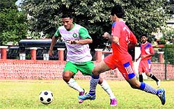 Players in action in a match during the Dehradun District Super League Tournament under way at the Police Lines ground in Dehradun on Tuesday