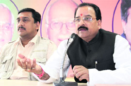 Leader of the Opposition in the Uttarakhand Assembly Ajay Bhatt (right) addresses a press conference in Dehradun on Tuesday.