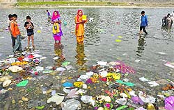 Polythene bags, plastic bottles and pieces of clothes left by devotees in the Tawi river on Tuesday