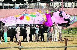 Workers try to erect an effigy of Ravana in Jammu on Tuesday