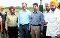 Administration officials with villagers at the common land at Rurka village in Ludhiana district