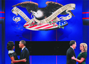 US President Barack Obama (left) and Republican presidential candidate Mitt Romney welcome their spouses Michelle (L) and Ann on the stage after the end of the debate. 