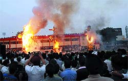 Massive effigies of demon king Ravana, his brother Kumbhakarna and son Meghnad burn on the grounds of MSD Senior Secondary School in Bathinda to mark the Dussehra celebrations on Wednesday